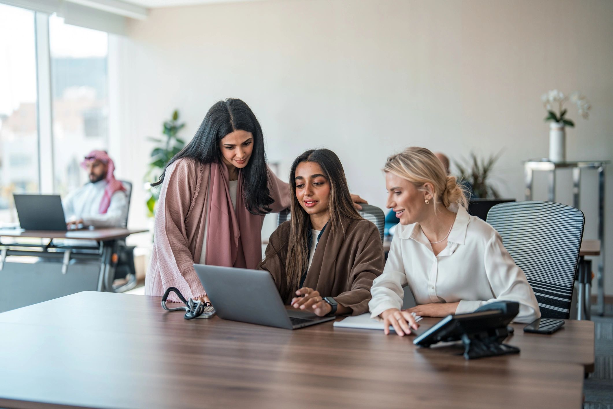 Business technology team collaborating at a conference table