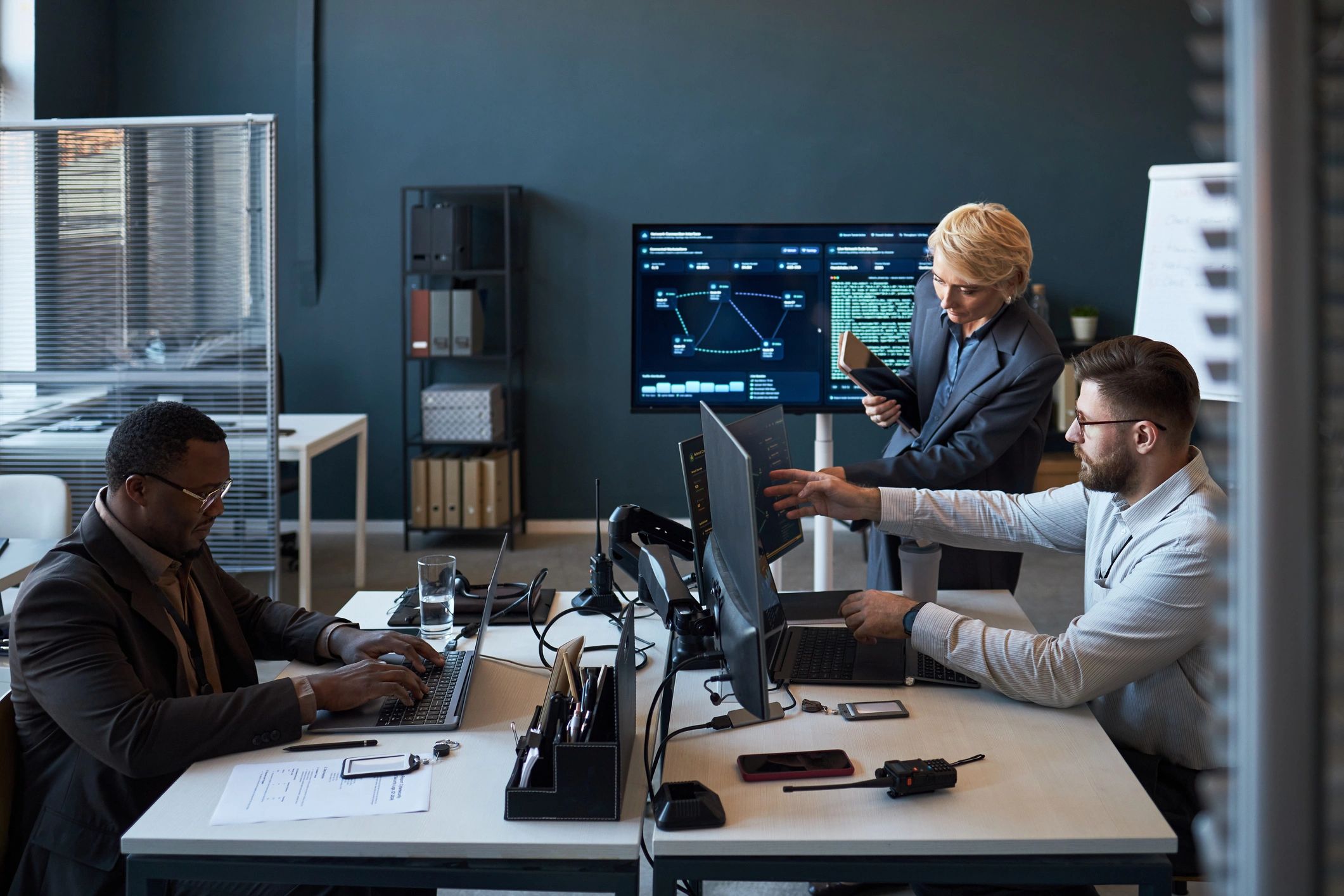 Team reviewing cybersecurity dashboards